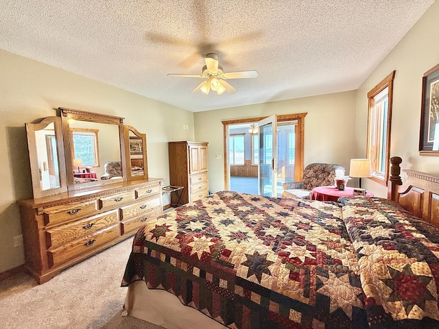 bedroom featuring light colored carpet, access to outside, a ceiling fan, and a textured ceiling
