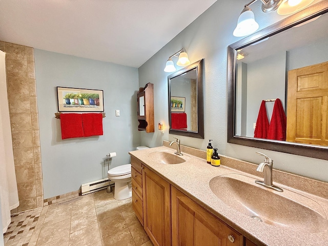 bathroom featuring baseboard heating, toilet, double vanity, a tile shower, and baseboards