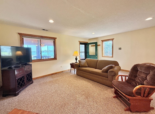 living room with baseboards, light colored carpet, recessed lighting, and a textured ceiling