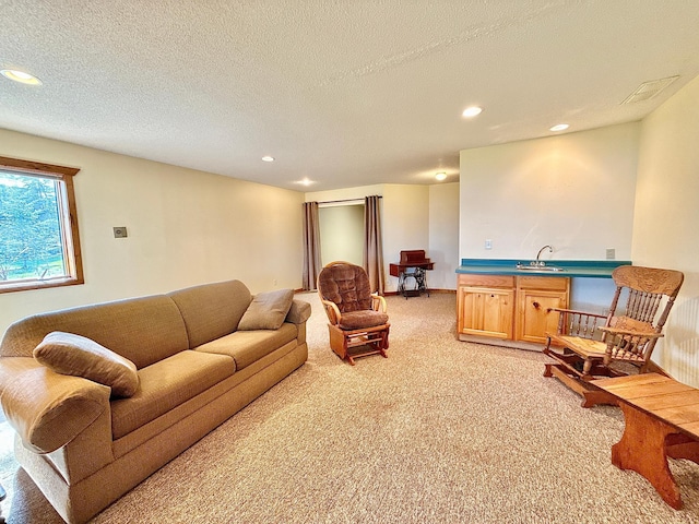 living room with light colored carpet, recessed lighting, a textured ceiling, and bar area