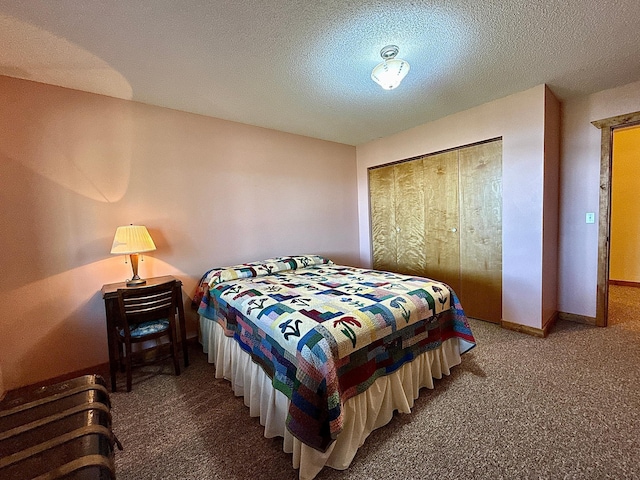 bedroom with carpet, a textured ceiling, and baseboards