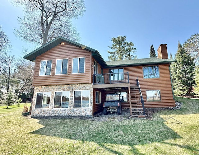 back of property featuring stairway, stone siding, a chimney, and a yard