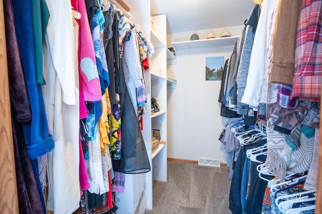 spacious closet with visible vents and carpet