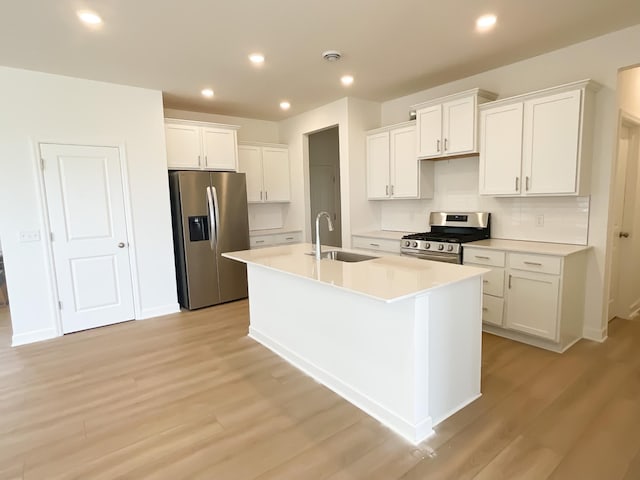2458 Jandell Ave NE, Saint Michael, MN 55376 - kitchen with stainless steel appliances, light wood-type flooring, a kitchen island with sink, white cabinets, and recessed lighting