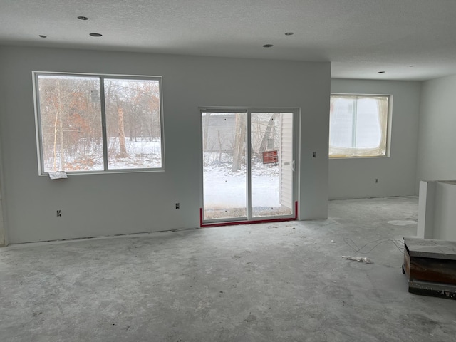 unfurnished living room featuring a textured ceiling