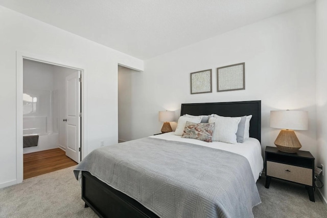 bedroom featuring carpet floors, visible vents, and ensuite bathroom