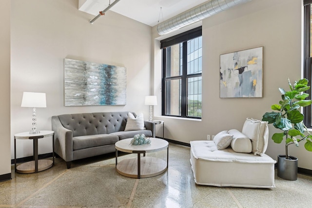 350 Saint Peter St Unit 704, Saint Paul, MN 55102 - living room with baseboards and speckle patterned floor