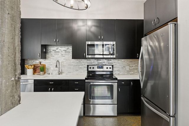 350 Saint Peter St Unit 704, Saint Paul, MN 55102 - kitchen featuring stainless steel appliances, a sink, light countertops, and dark cabinetry