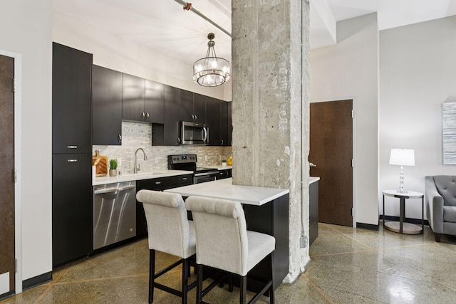 350 Saint Peter St Unit 704, Saint Paul, MN 55102 - kitchen with appliances with stainless steel finishes, light countertops, a breakfast bar area, dark cabinets, and a chandelier