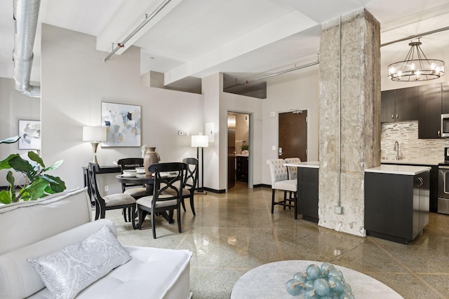 350 Saint Peter St Unit 704, Saint Paul, MN 55102 - living room featuring baseboards and a chandelier