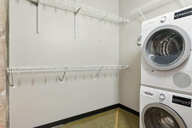 350 Saint Peter St Unit 704, Saint Paul, MN 55102 - clothes washing area featuring stacked washing machine and dryer and baseboards