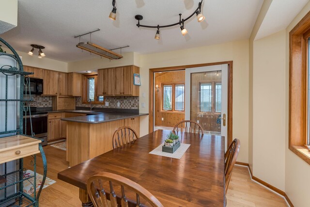 2324 Fair St, Mankato, MN 56001 - dining room with plenty of natural light, rail lighting, light wood finished floors, and baseboards