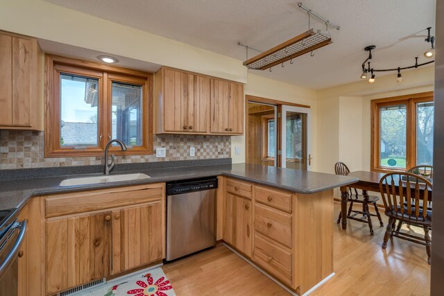 2324 Fair St, Mankato, MN 56001 - kitchen featuring a sink, appliances with stainless steel finishes, a peninsula, and dark countertops