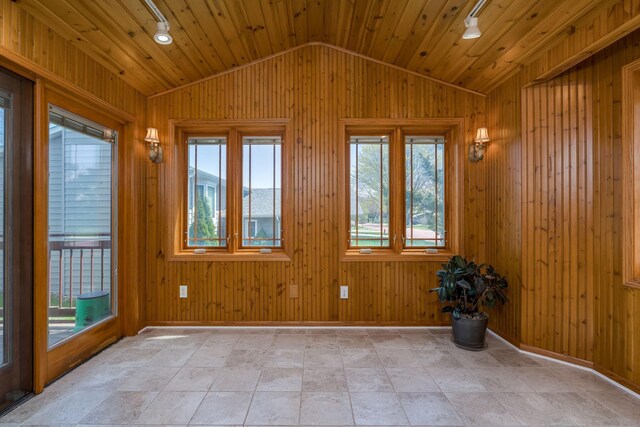 2324 Fair St, Mankato, MN 56001 - unfurnished room with baseboards, wooden walls, and vaulted ceiling