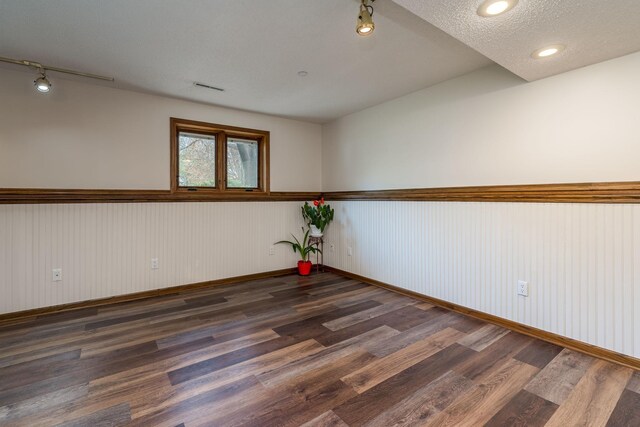 2324 Fair St, Mankato, MN 56001 - empty room featuring a wainscoted wall, rail lighting, wood finished floors, and visible vents