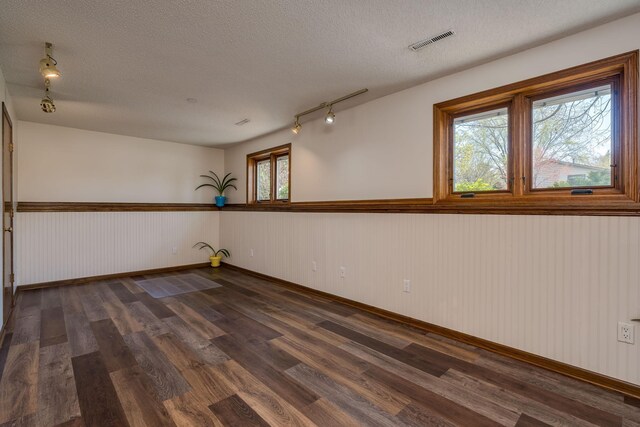 2324 Fair St, Mankato, MN 56001 - empty room with a healthy amount of sunlight, track lighting, dark wood finished floors, and visible vents