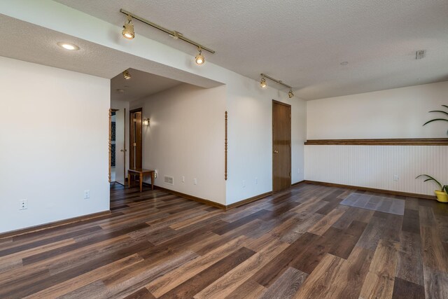 2324 Fair St, Mankato, MN 56001 - empty room featuring baseboards, a textured ceiling, track lighting, and wood finished floors