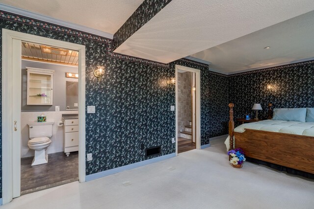 2324 Fair St, Mankato, MN 56001 - bedroom with crown molding, a textured ceiling, connected bathroom, and wallpapered walls