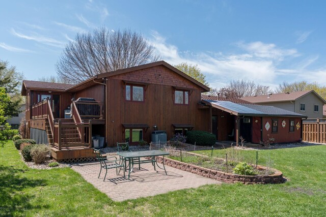 2324 Fair St, Mankato, MN 56001 - rear view of property with a lawn, a wooden deck, central air condition unit, fence, and a patio