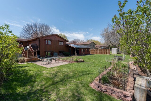 2324 Fair St, Mankato, MN 56001 - view of yard with an outdoor structure, a garden, fence, a patio, and stairs