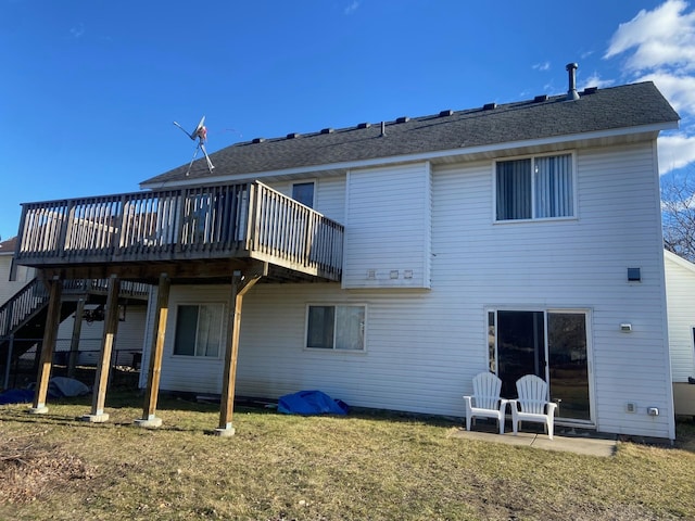 rear view of house with a lawn and a deck