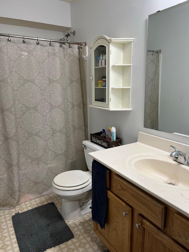 full bathroom with vanity, tile patterned floors, toilet, and curtained shower