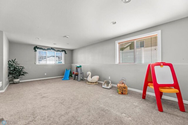 recreation room featuring carpet and baseboards