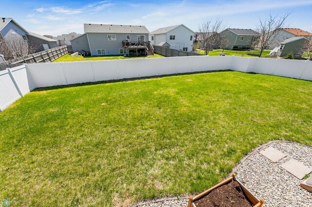 view of yard with a residential view and a wooden deck
