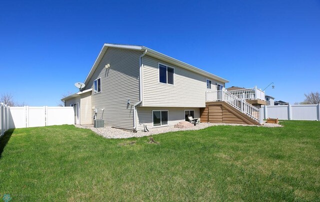 back of property featuring stairway, a wooden deck, and central AC