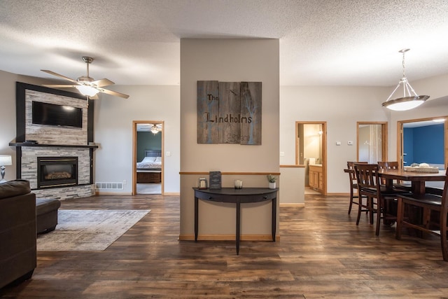 434 Fridell Cres, Red Wing, MN 55066 - living room featuring a ceiling fan, a fireplace, dark wood-style flooring, a textured ceiling, and baseboards