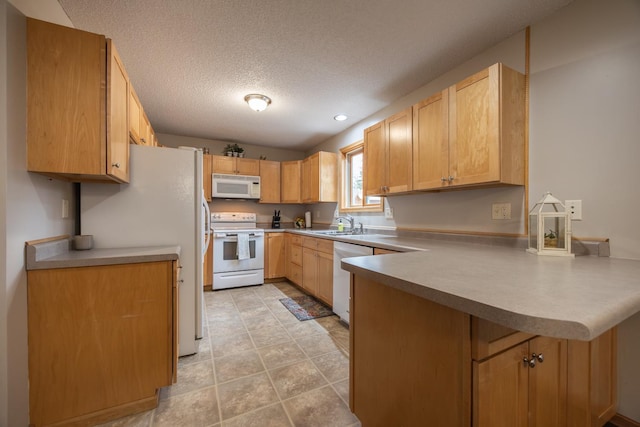 434 Fridell Cres, Red Wing, MN 55066 - kitchen with white appliances, a peninsula, a textured ceiling, a sink, and light countertops