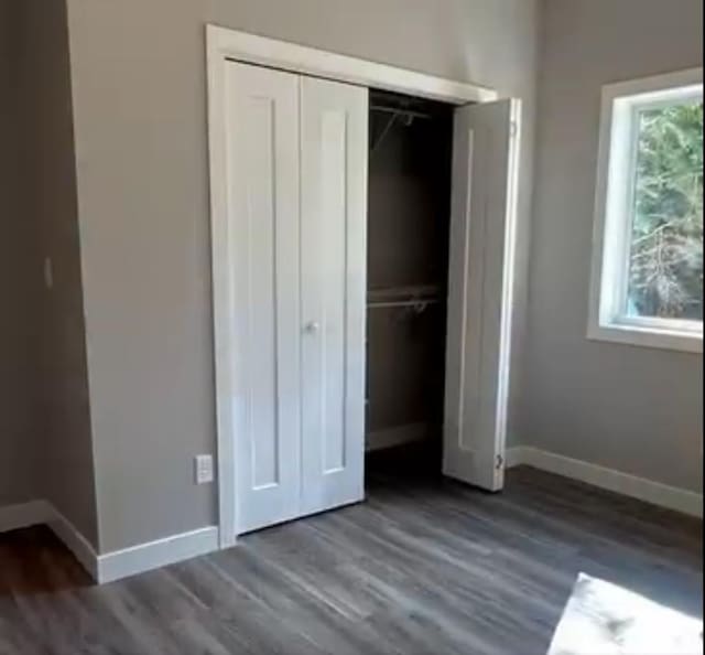 LOT11 Open Meadows Ct SE, Bemidji, MN 56601 - unfurnished bedroom with baseboards, a closet, and wood finished floors