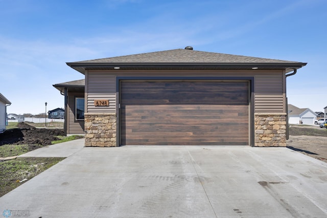 garage featuring concrete driveway