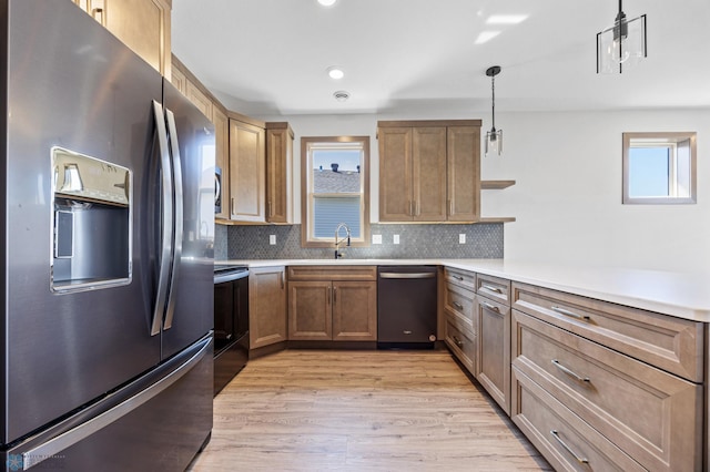 kitchen with appliances with stainless steel finishes, open shelves, light wood-style flooring, backsplash, and light countertops