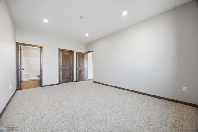 unfurnished bedroom with carpet floors, recessed lighting, ensuite bathroom, and baseboards