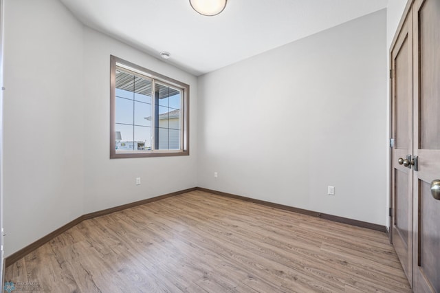 unfurnished room featuring light wood-style floors and baseboards