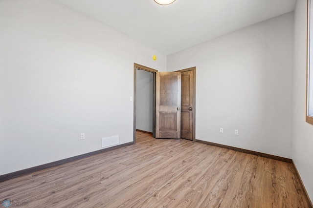 empty room with wood finished floors and baseboards