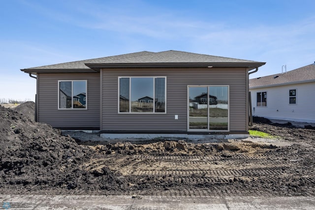 back of property featuring a shingled roof