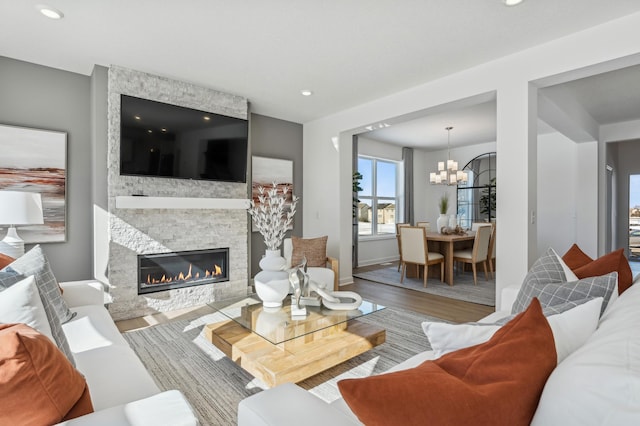 2704 Aspen Dr, Shakopee, MN 55379 - living room featuring wood finished floors, a chandelier, a fireplace, recessed lighting, and baseboards