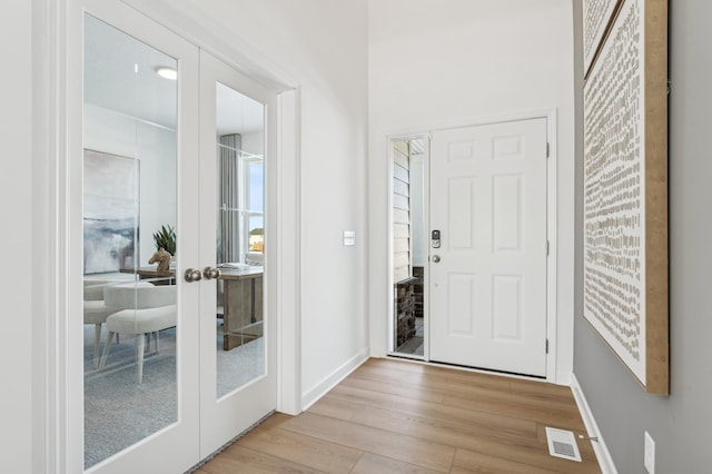 2704 Aspen Dr, Shakopee, MN 55379 - entrance foyer featuring french doors, wood finished floors, and baseboards