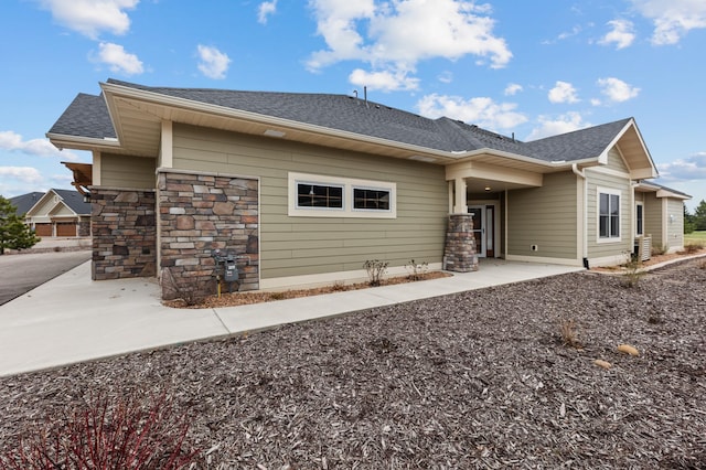 view of front of property featuring roof with shingles
