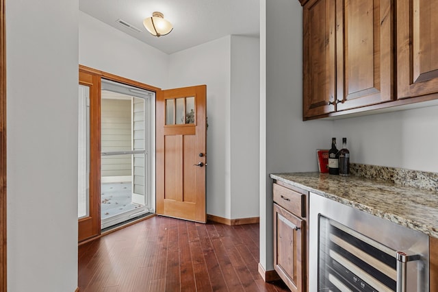 bar featuring visible vents, wine cooler, baseboards, dark wood-style floors, and a dry bar