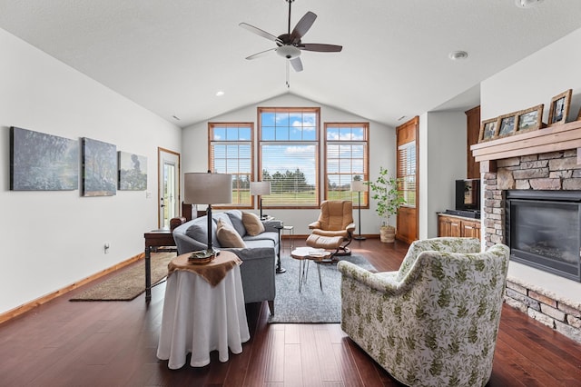 living area with baseboards, a fireplace, a ceiling fan, and lofted ceiling