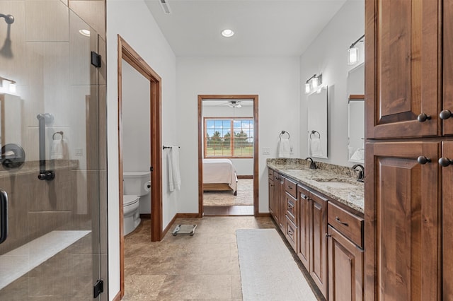 ensuite bathroom with connected bathroom, ceiling fan, a shower stall, and a sink