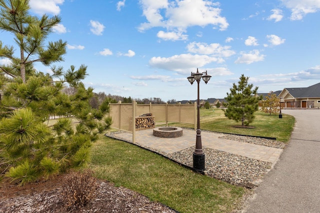 view of yard with a patio and an outdoor fire pit