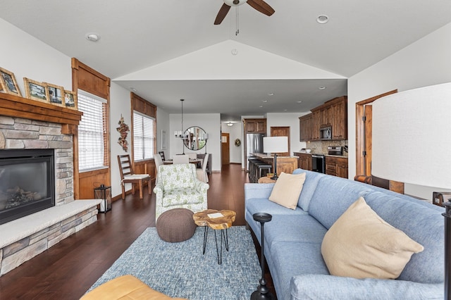 7466 Fairway Ln, Breezy Point, MN 56472 - living room featuring a ceiling fan, a fireplace, vaulted ceiling, dark wood finished floors, and a chandelier