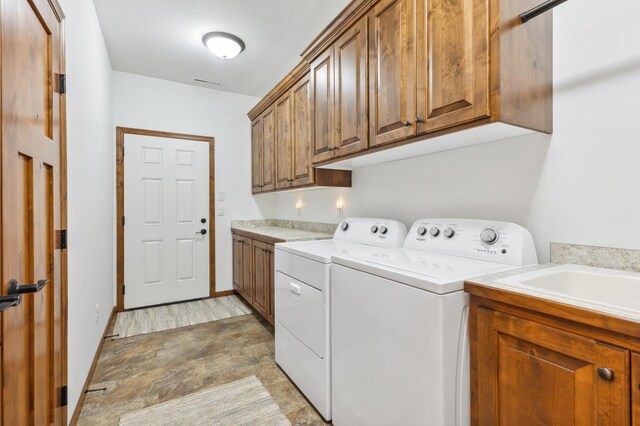 7466 Fairway Ln, Breezy Point, MN 56472 - laundry area with cabinet space, washing machine and clothes dryer, and stone finish flooring