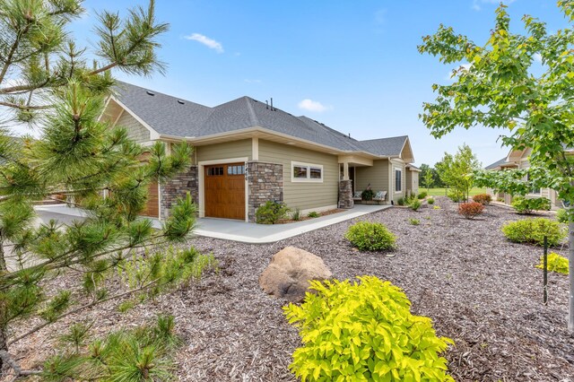 7466 Fairway Ln, Breezy Point, MN 56472 - view of front of property featuring an attached garage, a shingled roof, and stone siding