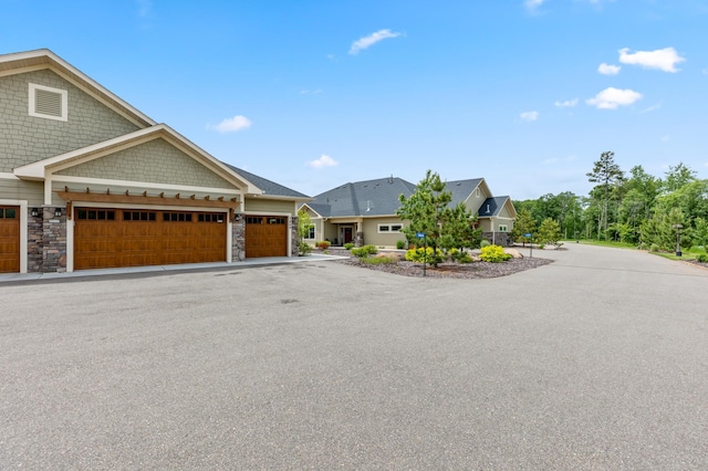 7466 Fairway Ln, Breezy Point, MN 56472 - view of front facade with stone siding and an attached garage