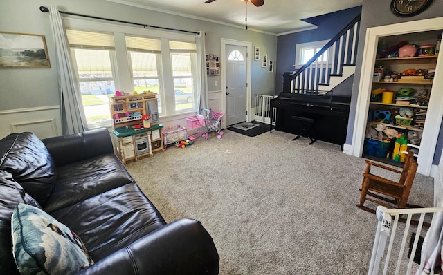 822 4th Ave, Madison, MN 56256 - carpeted living room with ornamental molding, stairs, and ceiling fan